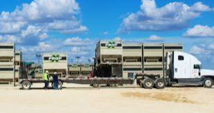 Truck hauling sandbox equipment